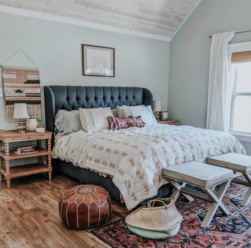 A dressed Stearns and Foster mattress on a navy quilted bed frame with wooden side table.jpg