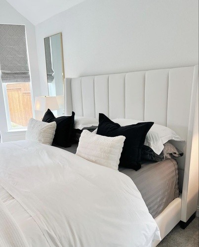 Head of S&F mattress, with plush bedding and headboard
