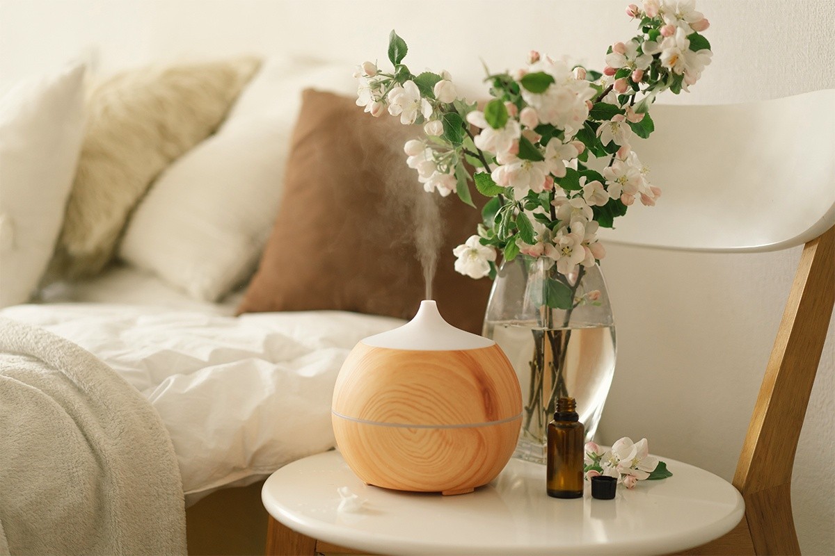 Oil diffuser and flowers sitting bedside