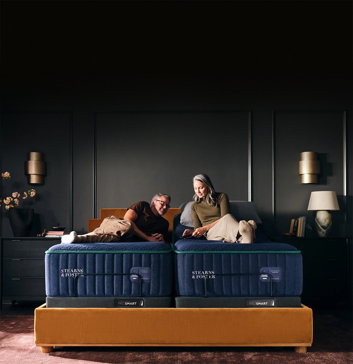 medSm couple sitting on a split king Reserve with an adjustable base lifting the head of one side