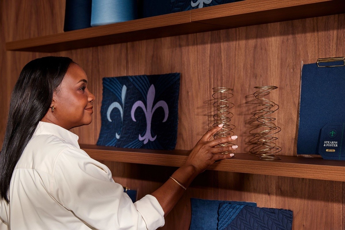 Woman reaching toward an intellicoil on a shelf