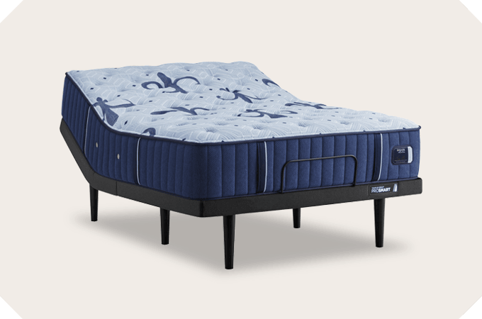 An Estate mattress on an adjustable base with a tan background