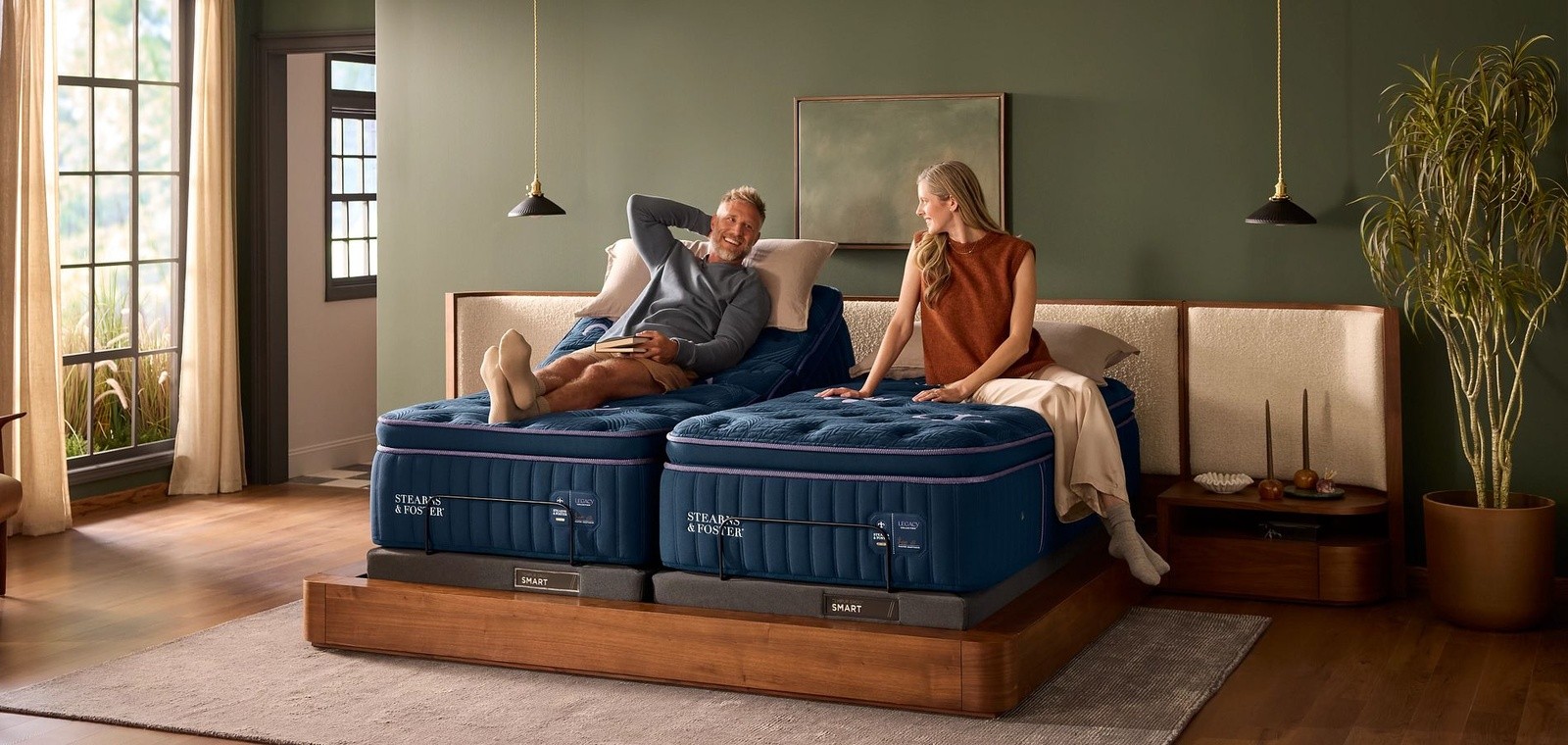 A split king legacy mattress with a person on each mattress