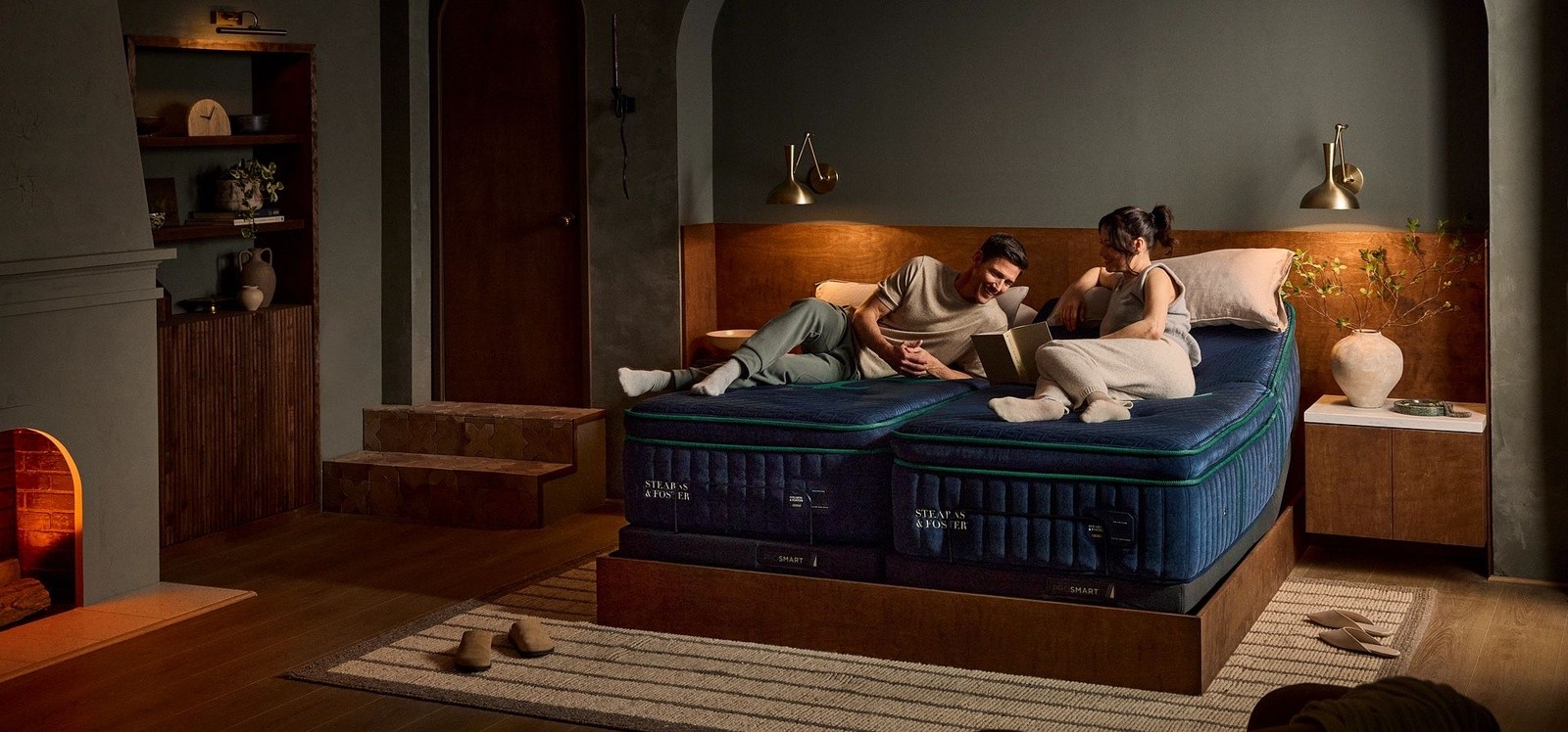 Two people on a split king reserve pillow top on an adjustable base