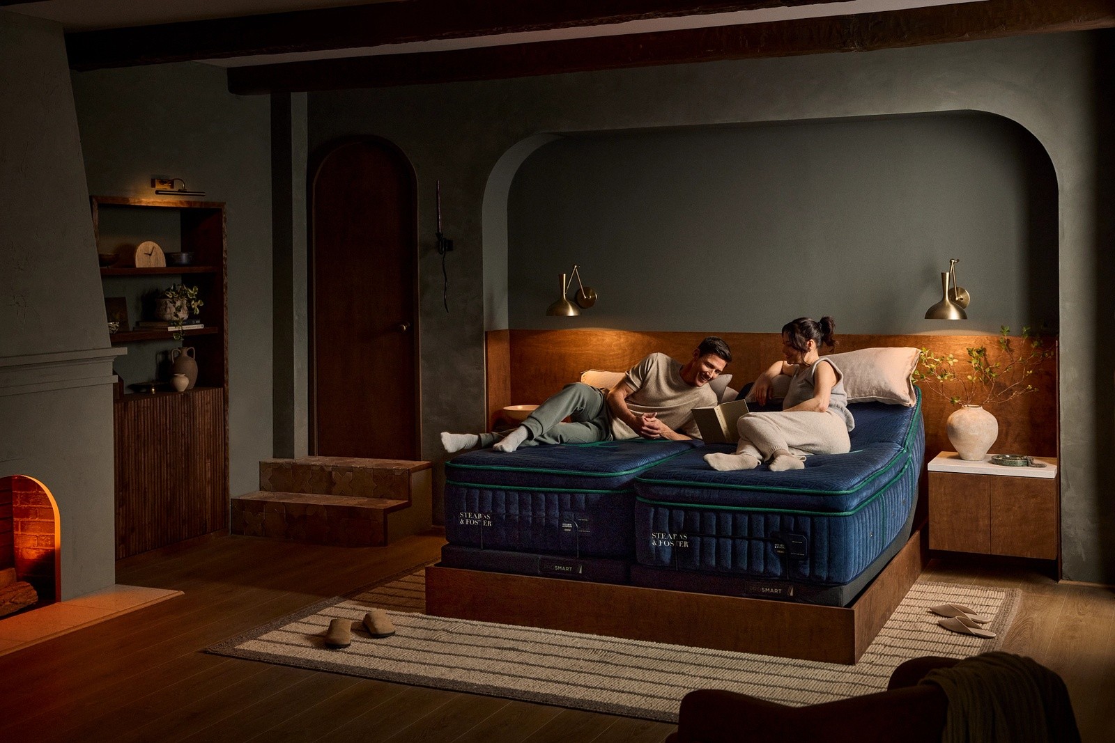 Two people laying on a split king reserve mattress with adjustable base