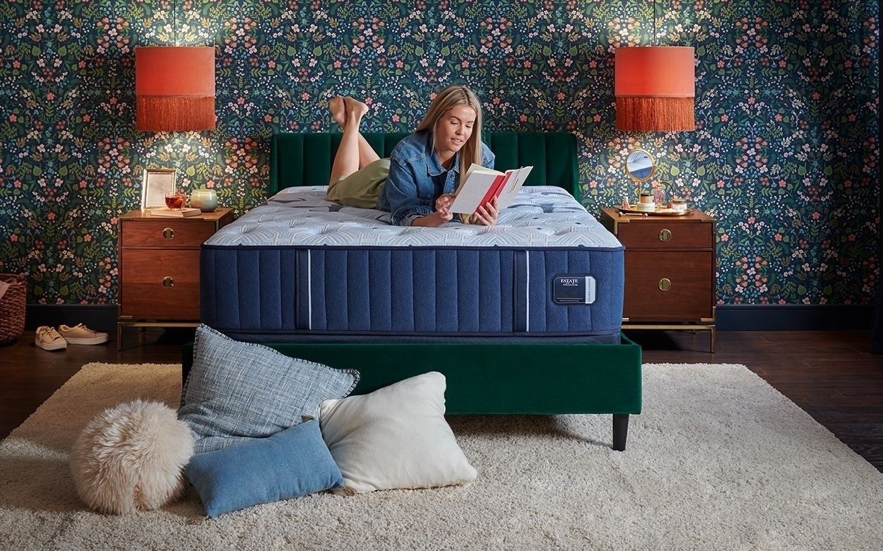 a woman reading on the Estate tight top mattress