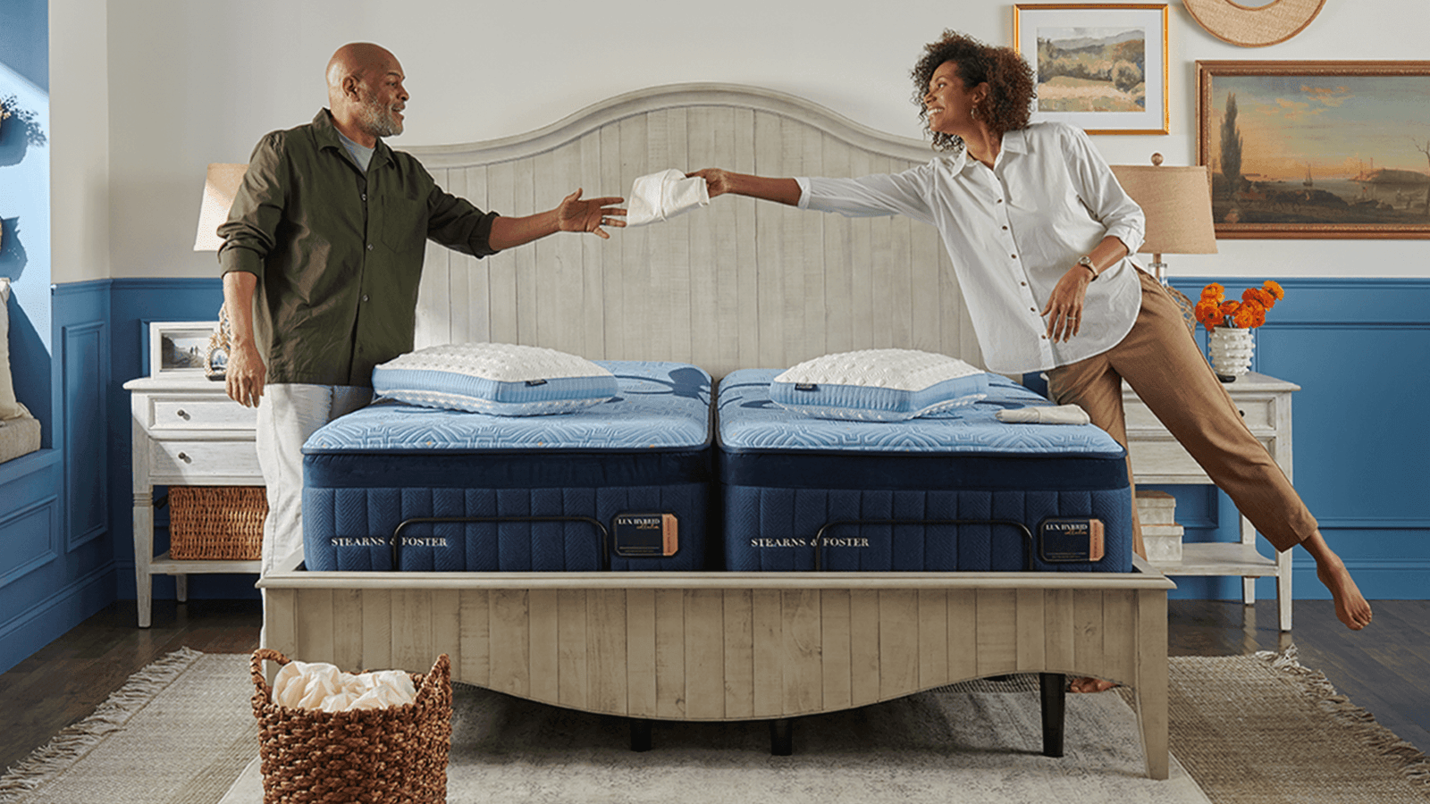 A couple putting their Stearns & Foster sheets on their mattress