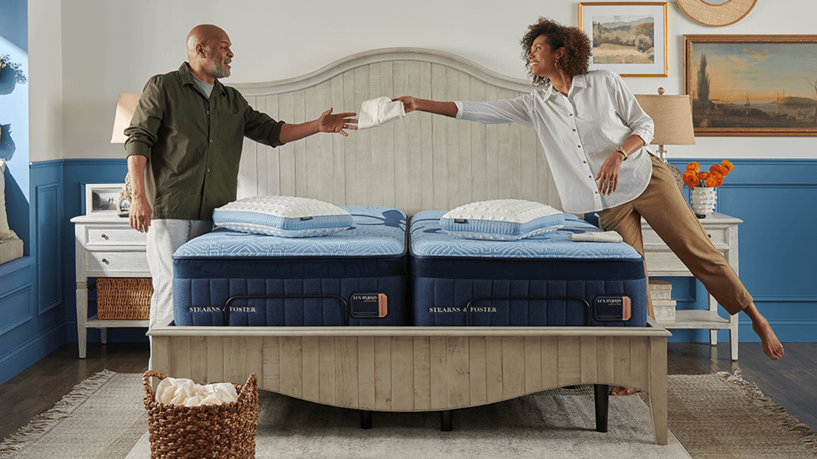 A couple putting their Stearns & Foster sheets on their mattress